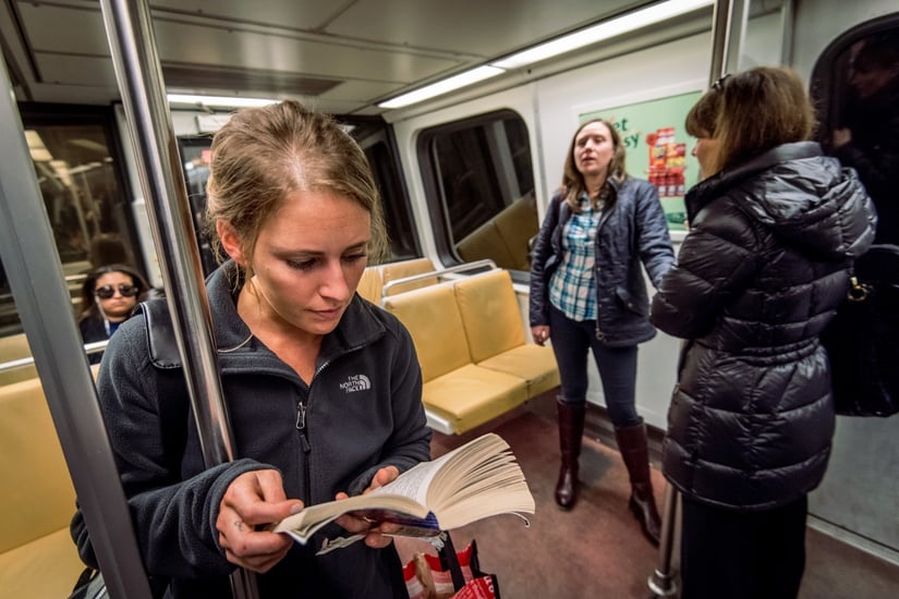 WomanReadingBookOnMetro.jpg