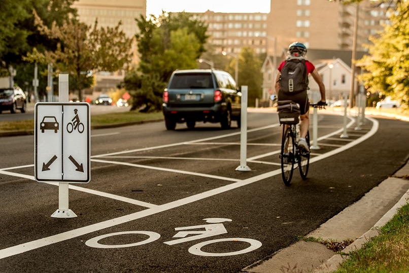 BikerOnProtectedBikeLane.jpg