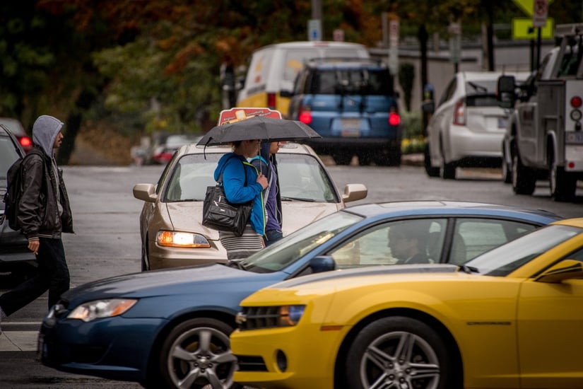 PeopleWalkingInRain_CarsPassing.jpg