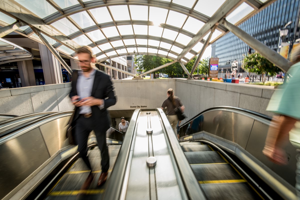 man-exiting-metro-escalators