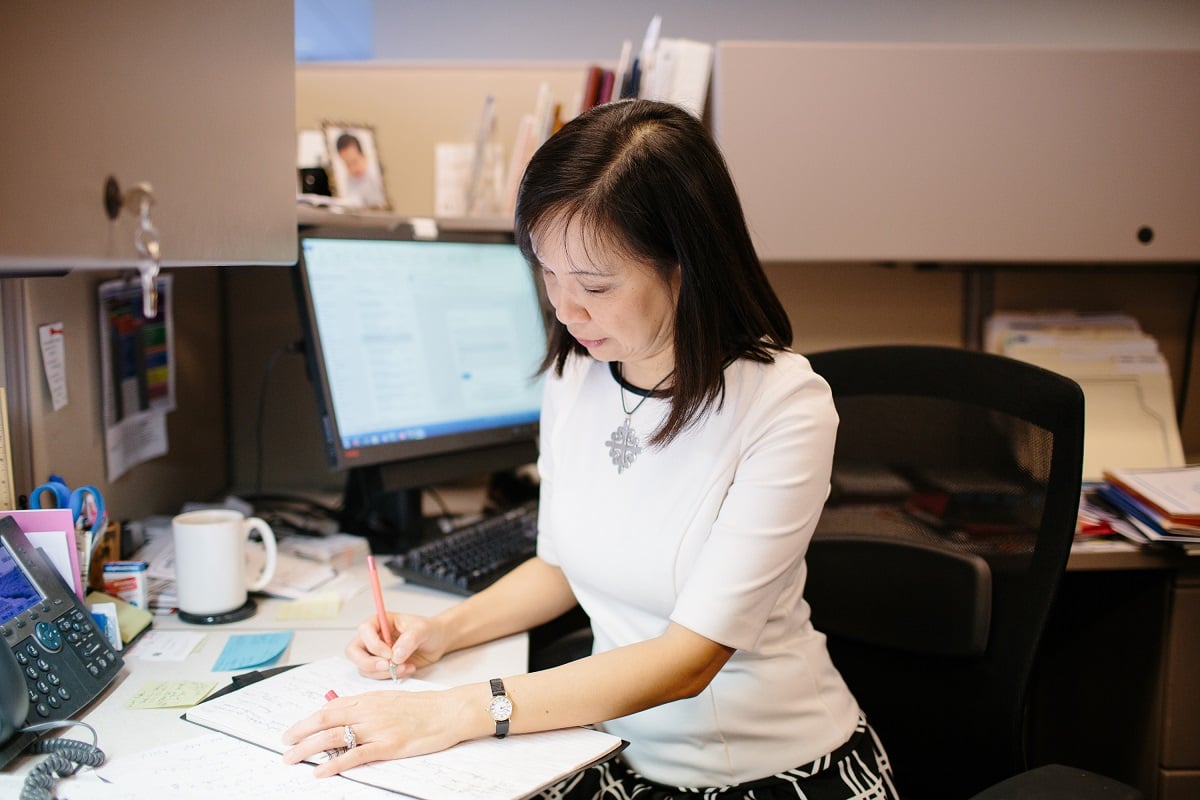 woman-working-at-desk-writing