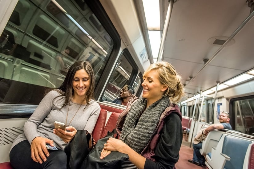 People on metro, using transit apps