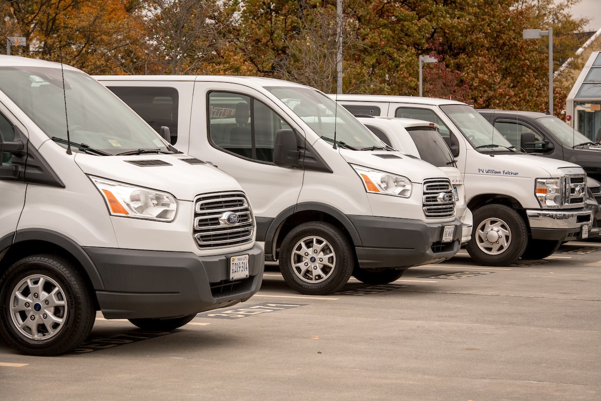 group of white vans in parking lot-1