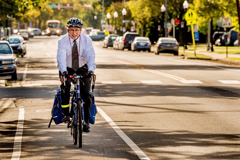 man-in-tie-riding-back-on-street